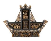 A Chinese carved wood and gilt decorated screen: of arched outline, surmounted by dragons,