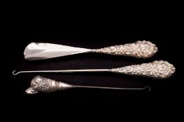 A silver and steel button hook: the handle modelled as a spaniel's head, marks worn,