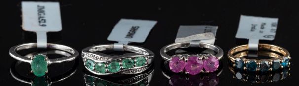 An emerald and diamond ring,: set with five oval cut emeralds, with eight cut diamond accents,