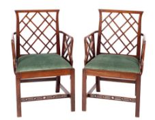 A pair of mahogany and green velvet upholstered Cockpen elbow chairs, in 18th century style,