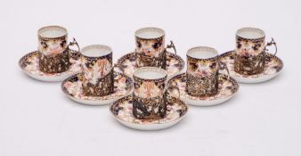A set of six Royal Crown Derby silver-mounted porcelain coffee cans and saucers: decorated in an
