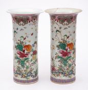 A pair of Chinese famille rose sleeve vases: each decorated overall with colourful flower sprays