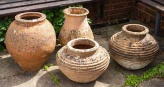 A group of four terracotta garden pots, 20th century,: the largest of ovoid form,