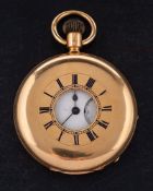An 18ct gold half hunter keyless pocket watch: the movement having an engraved balance cock to the