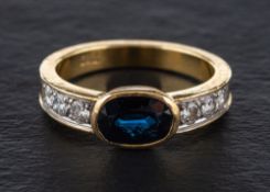 A sapphire and round, brilliant-cut diamond ring,: calculated sapphire weight ca. 1.