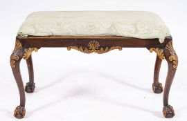 A carved and parcel gilt walnut long stool in George II style, late 19th century,