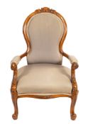 A Victorian carved walnut and upholstered armchair, circa 1870,