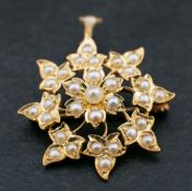 An 18ct gold, Victorian, seed pearl brooch/ pendant of stylised floral design,: length ca. 3.