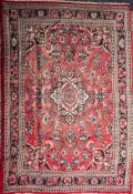 A Kashan carpet,: the rose field with a central ivory shaped lozenge pole medallion,