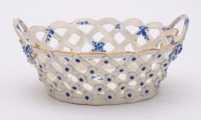 A First Period Worcester blue and white basket: of oval form with twig handles and applied with