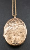 A 9ct gold locket pendant and ropetwist chain,: the locket pendant with engraved foliate decoration,