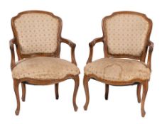 A pair of carved beech and upholstered fauteils in Louis XV style, late 19th / early 20th century,