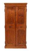 A hardwood shop cigar cabinet, early 20th century,: the moulded cornice above twin panel doors,