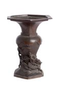 A Japanese bronze vase: with flared hexagonal rim, baluster body with entwined dragon,