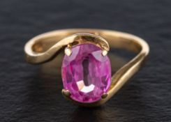 A synthetic pink sapphire ring,: stamped '750', length of ring head ca. 1.