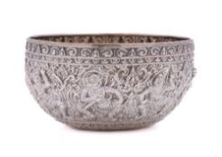An Indian silver bowl: of circular outline, with embossed decoration of deities, 13cm diameter,