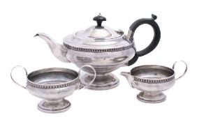 A George V silver pedestal three-piece tea set, maker Roberts & Dore Ltd, Birmingham,