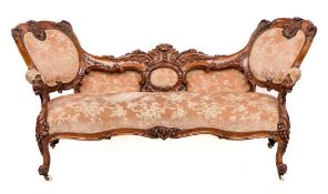 A Victorian carved walnut and upholstered love seat, circa 1870,