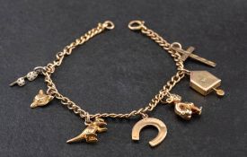 A curb-link charm bracelet and various charms,: the bracelet stamped '9CT',