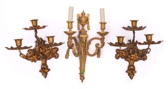 A pair of 19th century French gilt metal three-light wall appliques: with flared urn-shaped