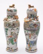 A pair of Chinese famille verte vases and covers: of baluster form with domed covers and lion-dog