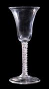 An English opaque twist wine glass: bell shaped bowl set on a straight single series opaque twist