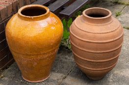 Two Continental terracotta garden urns/olive jars:, of ovoid form, one glazed,