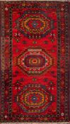 A Turkish rug:, the red field with triple serrated stellar medallions,