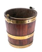 A 19th century mahogany and brass bound peat bucket: of coopered construction,