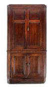 A George III oak corner cabinet, last quarter 18th century,