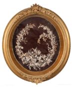 A pair of early 20th century oval paperwork floral displays: decorated with paper flowerheads and