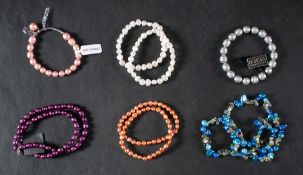 An Art Nouveau style white paste celluloid hair comb, a pair of convex, celluloid belt buckles,