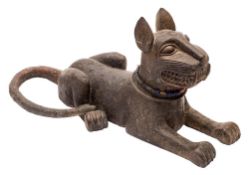 A Benin bronze statue of a recumbent leopard: with pricked ears and all over circular punched