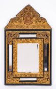 A Dutch ebonised wood and gilt repousse metal mounted wall mirror in 17th century style,