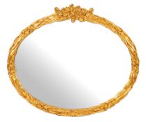 A gilt composition framed oval wall mirror, of recent manufacture,