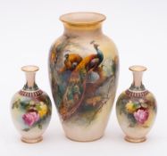 Three Royal Worcester porcelain vases: one of slender oviform painted by Reginald Austin with a