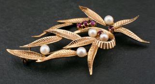 A 9ct gold cultured pearl and ruby brooch of foliate design,: diameter of cultured pearls ca. 3.