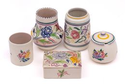 A group of five pieces of Poole Pottery: decorated with a range of floral designs,
