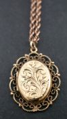A 9ct gold locket pendant and ropetwist chain,: the locket pendant with engraved foliate decoration,