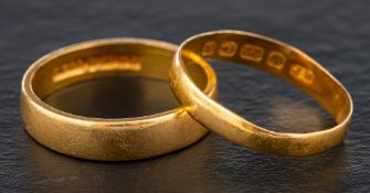 Two 22ct gold band rings,: both with hallmarks for Birmingham, one, 1984, ring size L; the other,
