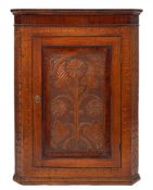A carved oak and walnut banded hanging corner cabinet, second half 19th century,