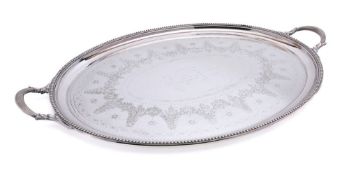 A plated oval serving tray: inscribed, with beaded border and reeded loop carrying handles,