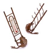 A novelty bronze desk top thermometer: modelled as a toad holding a ladder,