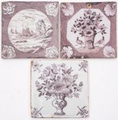 A group of three 18th century English manganese delftware tiles: one painted with a vase of flowers;