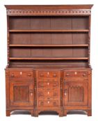 A late George III oak and crossbanded dresser, early 19th century and later,