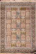A Kashmir rug:, with a shaded pink, pastel blue and green compartmented garden design,
