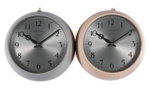 A pair of circular Synchronome 'Impulse' dial clocks: one painted grey the other cream,