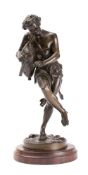 A 19th century bronze figure of a bacchanalian pipe player: wearing a lion skin whilst playing the