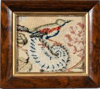 A Victorian woolwork picture: depicting a gallant and lady under a tree enclosed by a foliate