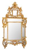 A French Regence carved giltwood marginal wall mirror:, with shaped domed cresting with mask,
